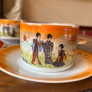 Antique vintage Zsolnay Pecs porcelain tea set of 5 cups and saucers with Japan Geisha pattern on orange iridescent base, 1920s