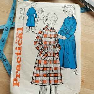 Puede incluir: Patrón de costura vintage titulado "Practical" con ilustraciones de abrigos infantiles. La portada muestra a un niño con un abrigo a cuadros rojos y blancos y a una niña con un abrigo azul. Una cinta métrica azul y unas tijeras en el fondo.