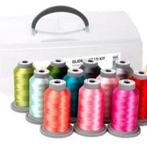 May include: A sewing thread kit with a clear plastic storage case and a black handle. The kit includes 12 spools of colorful thread in various shades of green, blue, pink, red, and yellow. The label reads "GLIDE THREAD KIT".