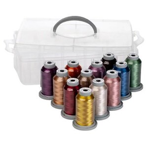 May include: A clear plastic storage case with a gray handle holds a collection of colorful spools of thread. The thread colors include purple, orange, gold, red, and blue. The spools are arranged in a neat display, ready for crafting projects.