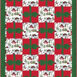 May include: A festive quilt featuring a repeating pattern of red gift boxes with green bows. The spaces between the boxes are filled with a winter scene of red barns, snow-covered trees, and a snowy road. The quilt has a green border.