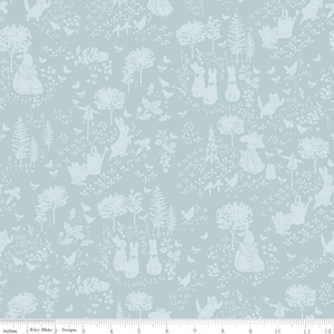 May include: Light blue fabric with a repeating pattern of white rabbits, trees, flowers, birds, and watering cans. The design includes a ruler along the bottom edge, with the text "Riley Blake Designs" and inch measurements.