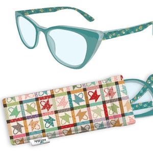 May include: Teal cat-eye glasses with floral patterned arms and a matching case. The case features a patchwork design with colorful star and basket motifs. The glasses are open, revealing the lenses.