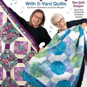 May include: A book cover titled "Step It Up With 5-Yard Quilts" featuring two women holding colorful quilts. The quilts have floral and geometric patterns in shades of purple, blue, and green. The book cover includes the text "8 New Quilt Designs!"