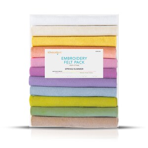 May include: A package of embroidery felt rolls in various pastel colors, including white, yellow, pink, and lavender. The package includes 15 rolls, each measuring 9 x 12 inches. The label reads "Embroidery Felt Pack Spring/Summer."