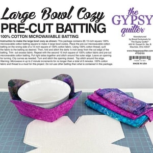 May include: A large bowl cozy kit with pre-cut batting. The kit includes a purple and pink bowl cozy holding a white bowl, along with folded fabric squares in shades of purple, blue, and pink. The text on the packaging reads "Large Bowl Cozy" and "100% Cotton Microwavable Batting."