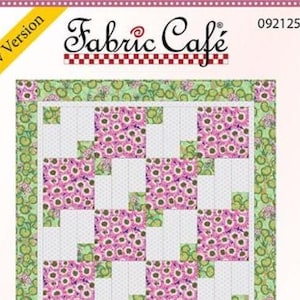 May include: A quilt pattern cover by Fabric Café labeled 092125-01 with a New Version banner. The design features a grid of alternating blocks: one with a pink and purple floral print and another with a white and grey dotted pattern, framed by a green border with a circular botanical motif.