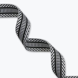 May include: A black and white woven ribbon featuring a central vertical striped pattern flanked by two outer borders with a diagonal chevron design. The ribbon is displayed in a series of gentle, flowing curves against a plain white background.