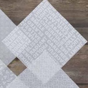 May include: A square sheet of light gray paper featuring a repeating pattern of white words including Bliss, Zesty, Happy, Festive, Elated, Radiant, Frolic, Carefree, Cheerful, Delighted, Pleasant, Lighthearted, and Greatful.