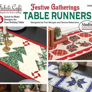 May include: A pattern booklet titled Fabric Café Festive Gatherings TABLE RUNNERS featuring 5 designs for a holiday table. The cover displays three quilted table runners with Christmas tree, geometric, and star patterns in red, green, and blue.