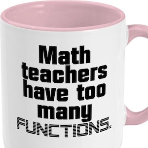 May include: White ceramic coffee mug with a pink rim. The mug has black text that reads "Math teachers have too many FUNCTIONS."