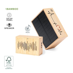 May include: A wooden speaker with a solar panel on top. The speaker has a heart and a music note symbol on it. The speaker is made of bamboo and has a black speaker grill. The speaker is labeled "BAMBOO" and "MUSIC".