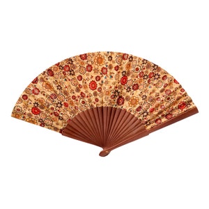 May include: A brown folding fan with a beige and red floral pattern.