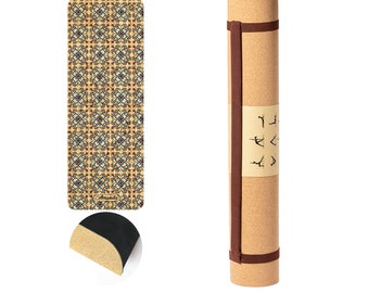 May include: A cork yoga mat with a brown strap and a patterned design. The mat is rolled up and has a brown strap with the word "Amanda" printed on it.
