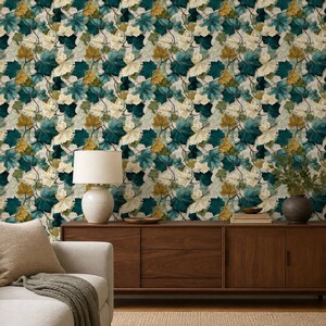 May include: Wallpaper featuring a dense, repeating pattern of maple leaves in shades of deep teal, muted gold, and cream. The leaves are layered across the surface, creating a botanical motif that covers the entire wall in a consistent design.