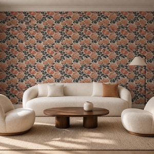 May include: A room featuring floral wallpaper with peach-colored roses and dark green leaves. A cream-colored curved sofa with three throw pillows, two cream-colored armchairs, and a dark wood oval coffee table with a small white vase.