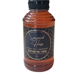 May include: A clear glass bottle of honey with a black label that reads "Sourwood Honey", "Premium Raw Unpasteurized", "STAFFORD HILL FARMS", "15 Losewood Road South Asheville NC 28801", "Net Weight 16 oz".