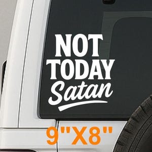 May include: White vinyl decal with the text "NOT TODAY Satan" in a bold, stylized font. The decal is 9" x 8" and is displayed on the rear window of a white SUV. The text is in white, contrasting against the dark window.