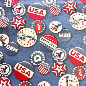 May include: A fabric pattern featuring various circular and star-shaped designs in red, white, and blue. The designs include the text "USA" and "DEMOCRAT", along with patriotic imagery like the Statue of Liberty and the American flag.