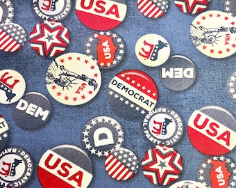 May include: A fabric pattern featuring various circular and star-shaped designs in red, white, and blue. The designs include the text "USA" and "DEMOCRAT", along with patriotic imagery like the Statue of Liberty and the American flag.