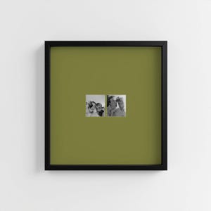 May include: A framed artwork with two small black and white photographs. The frame is black, and the background is olive green. The photographs show people in informal poses.