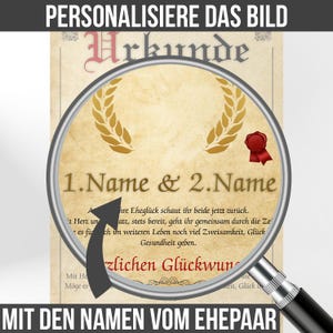 May include: A personalized certificate with the text "Urkunde" and space for names. The design includes a gold laurel wreath, a red wax seal, and German text. The certificate is viewed through a magnifying glass.