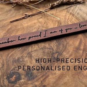 May include: A brown leather bracelet with the inscription "Always remember how proud I am of you - love always, Mum". The bracelet is engraved with high-precision personalized engraving.
