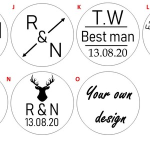 May include: A set of 10 round, black and white wedding favor stickers with various designs. The designs include a deer, a ring, a heart, and the text "R&N" and "T.W. Best man".
