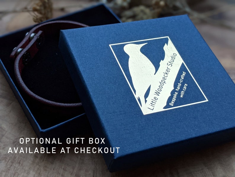May include: A blue gift box with a white woodpecker logo and the text "Little Woodpecker Studio" and "Bespoke, hand-crafted with care".