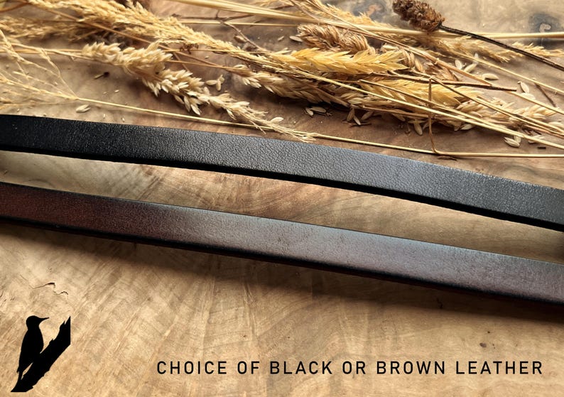 May include: Close-up of two leather straps, one black and one brown, with a textured surface. The text "CHOICE OF BLACK OR BROWN LEATHER" is at the bottom. Dried wheat stalks are in the background.