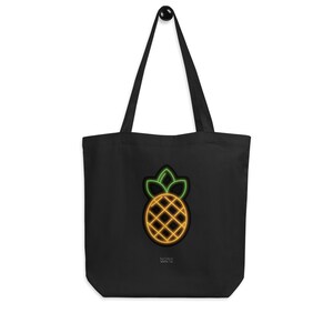 Può includere: Borsa tote nera con un design a forma di ananas in stile neon. L'ananas è delineato in giallo e arancione con foglie verdi. La borsa ha manici lunghi e il testo "NONY" è in basso.