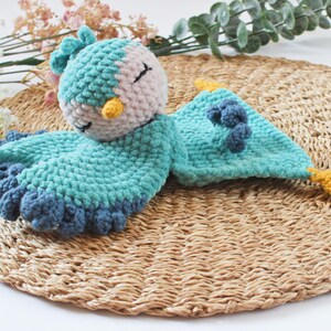 Soft bird-shaped snuggle blanket for babies, made from gentle fabric for comfort and relaxation, perfect for naps and bedtime.