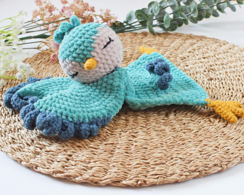 Soft bird-shaped snuggle blanket for babies, made from gentle fabric for comfort and relaxation, perfect for naps and bedtime.