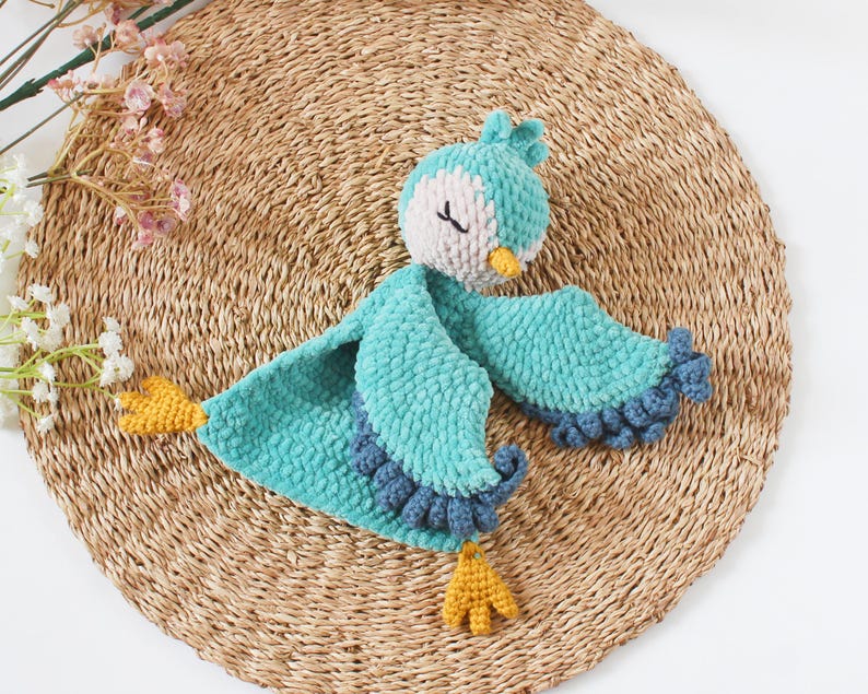 Soft bird-shaped snuggle blanket for babies, made from gentle fabric for comfort and relaxation, perfect for naps and bedtime.
