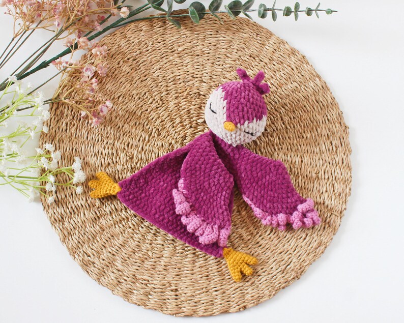 Soft bird-shaped snuggle blanket for babies, made from gentle fabric for comfort and relaxation, perfect for naps and bedtime.