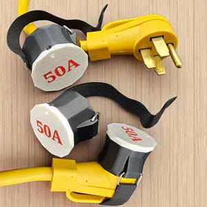 May include: Yellow and black electrical connectors with a black strap. The connectors have a white face with the red text "50A". The image shows the male and female ends of the electrical connectors.