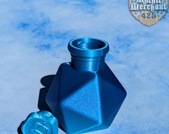May include: A blue, geometric-shaped bottle with a matching blue lid. The bottle is made of a smooth, matte material and has a slightly textured surface.