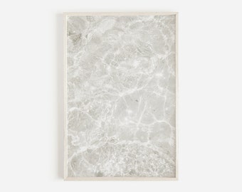 May include: A framed print of a white and gray marble-like texture. The frame is white and has a simple design.