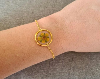 Golden bracelet of pressed resin flowers