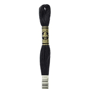 May include: A spool of black DMC 25 embroidery floss. The label reads "Mouline Special" and "25" with 8 m (8.7 yd). The bottom of the spool has the number "310" and a barcode.