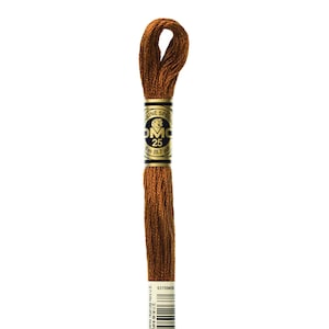 May include: A spool of DMC embroidery floss in color 433, a brown shade. The spool is labeled with the DMC logo, the color number, and the length of the floss in meters and yards.