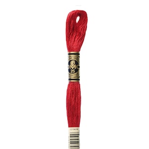 May include: A spool of DMC 25 embroidery floss in a vibrant red color, shade 321. The label indicates 8.7 yards of thread. The spool has a black and gold label with the DMC logo and a barcode.