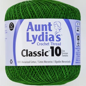 May include: A green ball of Aunt Lydia's Classic 10 crochet thread. The label features the brand name, product details, and the text "100% Mercerized Cotton." The thread is tightly wound and ready for crafting.