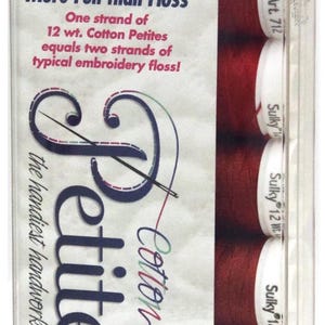 May include: A package of Sulky 12 wt. Cotton Petites embroidery thread in a clear plastic container. The thread spools are a deep red color. Text on the package reads "Easier, Faster and More Fun than Floss" and "the handiest handwork thread."