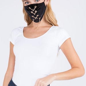 May include: Black velvet face mask with gold chain detail and criss-cross lacing.