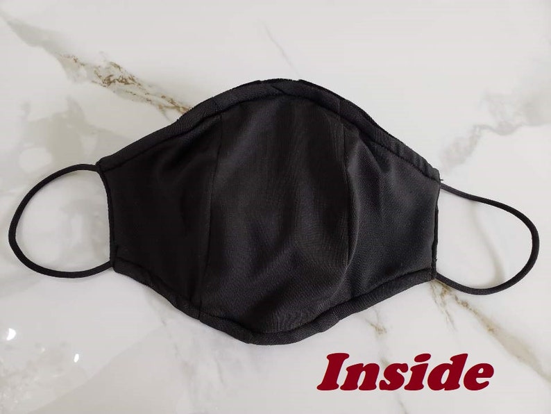 May include: Black fabric face mask with elastic ear loops. The inside of the mask is shown in the image. The word "Inside" is written in red letters below the mask.