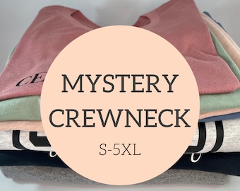 May include: A stack of mystery crewneck t-shirts in various colors, including pink, green, beige, gray, and black. The shirts are folded and stacked on top of each other. A circle with the text "MYSTERY CREWNECK S-5XL" is in the center of the image.