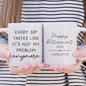 May include: Two white ceramic mugs with black text. One mug reads "EVERY SIP TASTES LIKE IT'S NOT MY PROBLEM anymore." The other mug says "Happy Retirement 2024" with a heart and the name "Charlotte".