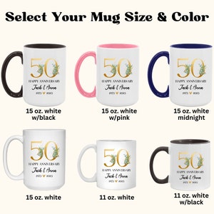 May include: Six white mugs with different colored rims and handles. The mugs feature a gold 50th anniversary design with green leaves and the text "Happy Anniversary Jack & Anna 1973 &hearts; 2023". The mugs are available in 11 oz and 15 oz sizes.