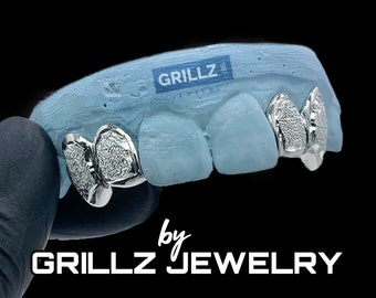 Most chosen custom fangs, solid frames, FREE diamond dust, middle two teeth skipped, high quality, fast, express delivered by Grillz jewelry